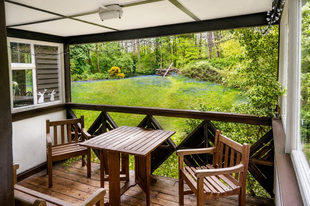 Verandah overlooking lawn and woodland grounds at Windy Gap